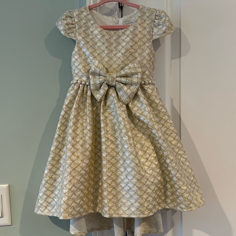 A gold and cream colored toddler dress